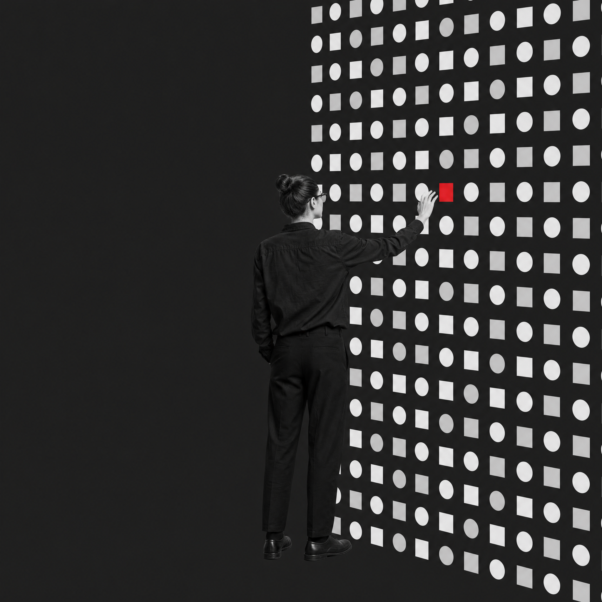 A designer at a wall of repeating interface components