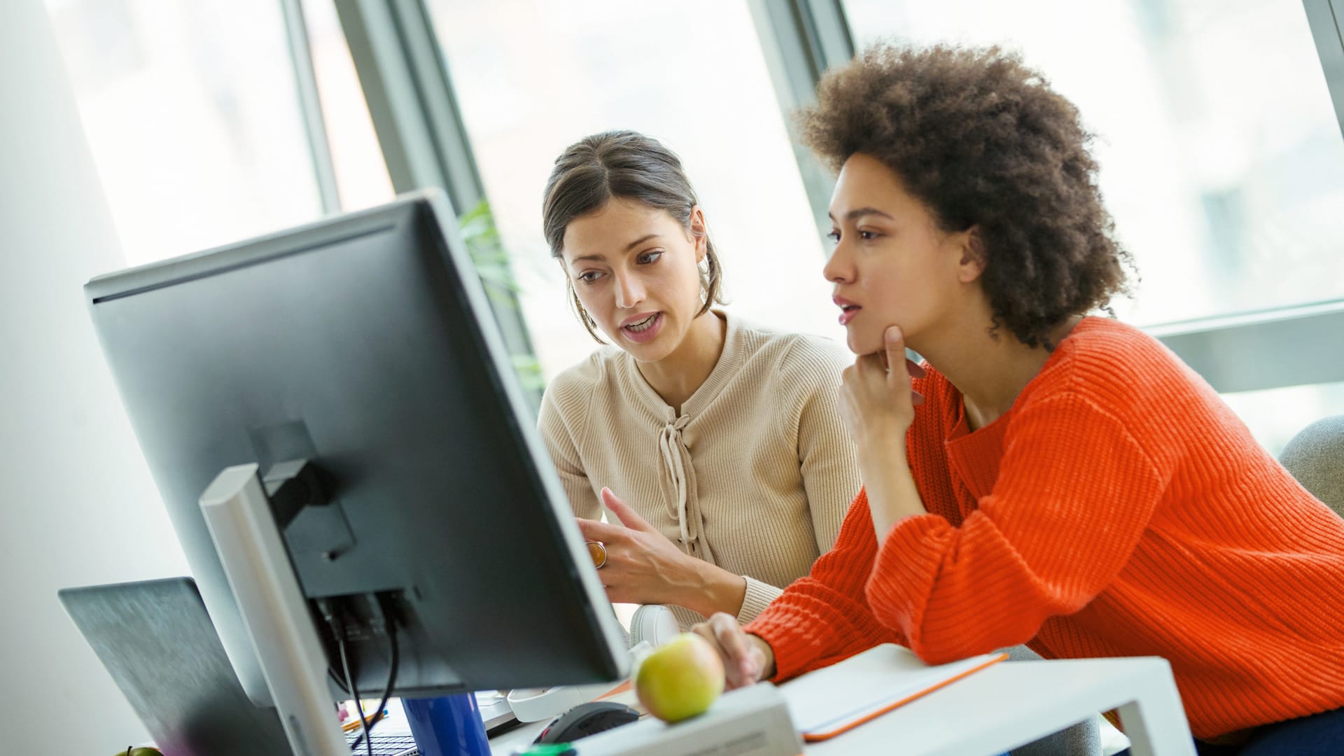 Two individuals at a computer