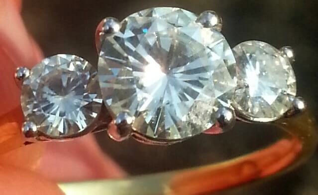 image of a moissanite ring with three round brilliant diamonds 