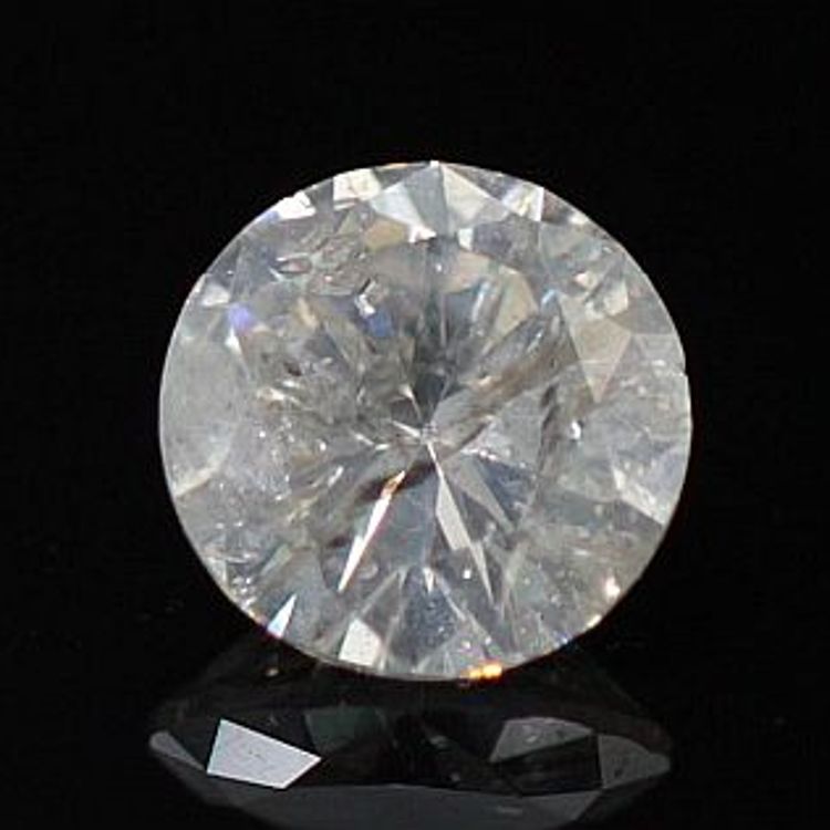 Round diamond against a black background that has turned milky from twinning wisps