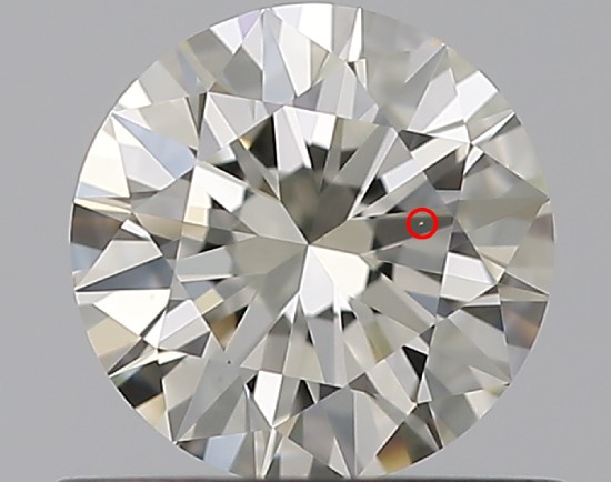 A round diamond against a gray background has a red circle around a small white line, called a feather