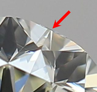 1/4 of a diamond with a red arrow pointing to a flat section of the diamond called a natural