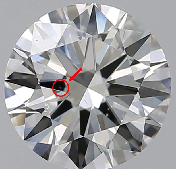 Round diamond against a gray background with red circle around a diamond needle with arrow pointing to it.