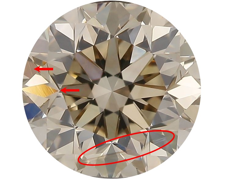 A round diamond against a white background with two red arrows and a red circle highlighting lines in the diamond called internal graining