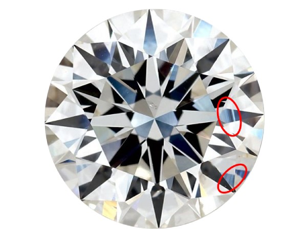 Round diamond against a white background with two circles around lines on the diamond called "surface graining"