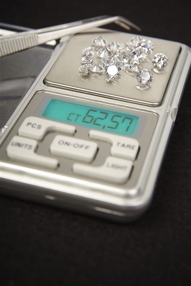 60 carats of diamonds being weighed on a scale