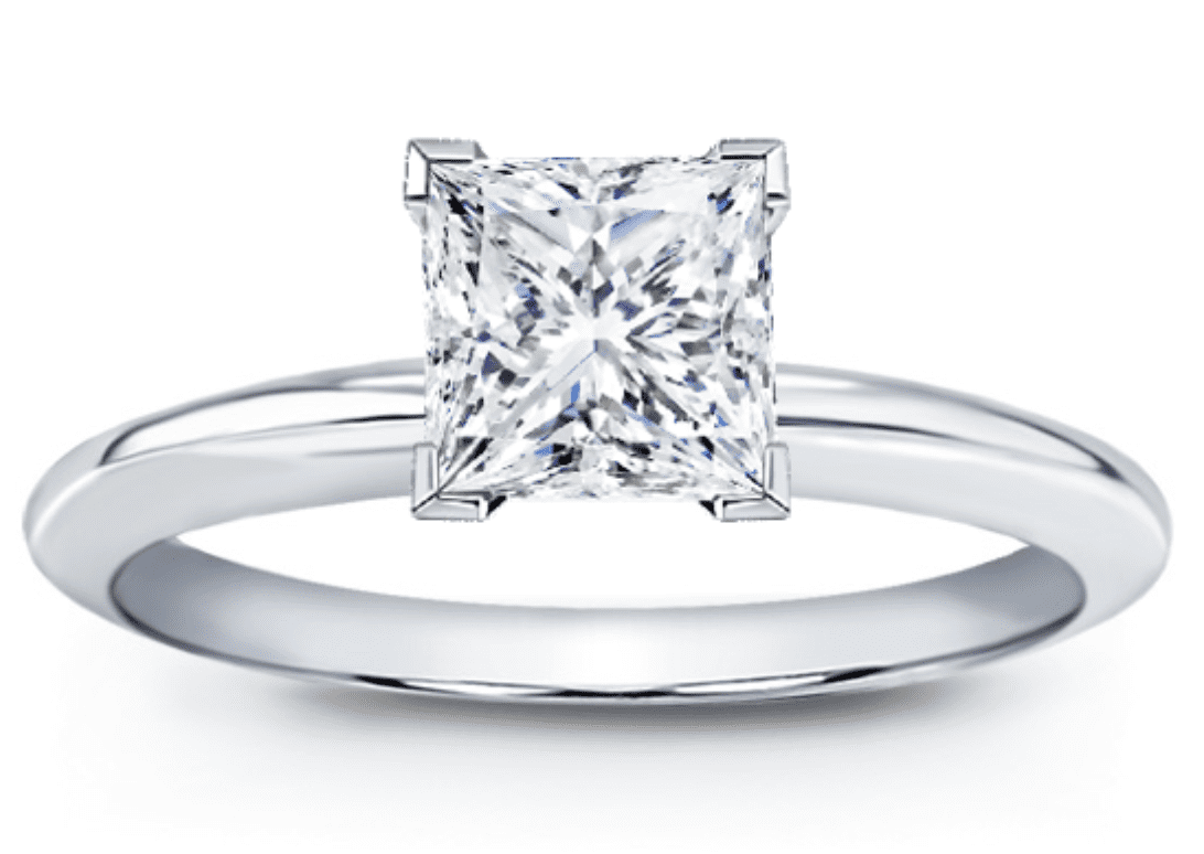 Solitaire princess cut diamond ring with v-cap prongs to protect the corners set in white metal 