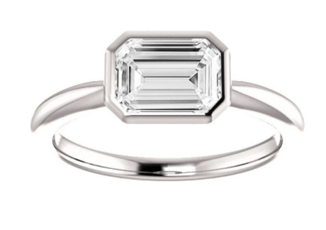 East/West bezel set emerald cut solitaire ring in white metal 