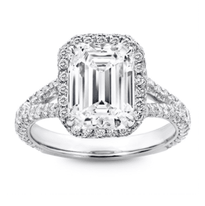 emerald cut center stone with a halo, split shank and pave in white metal 