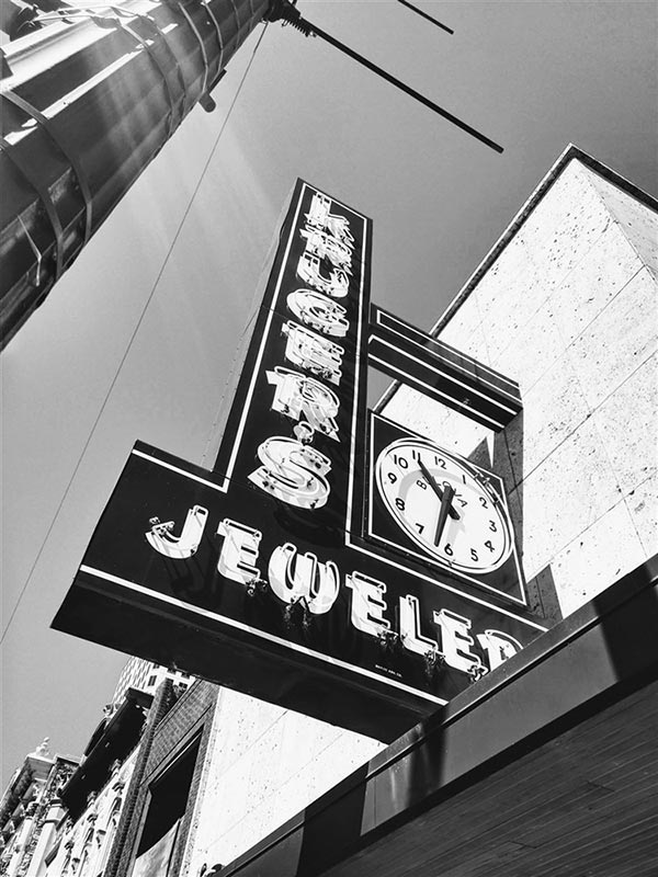 Signboard of a jeweler's store featuring a clock