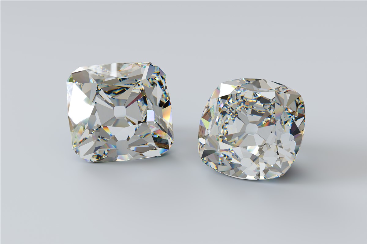 Two old mine cut diamonds side by side 