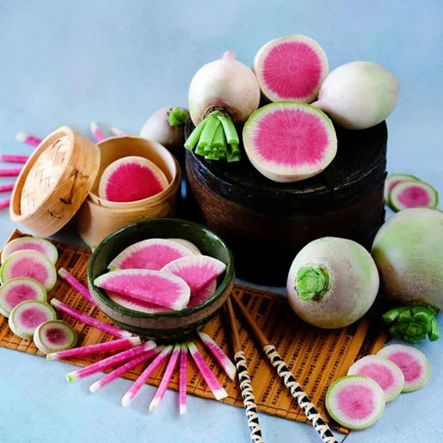Freshly harvested fall radishes including Watermelon Radish, Minowase Daikon, and Blue Autumn.