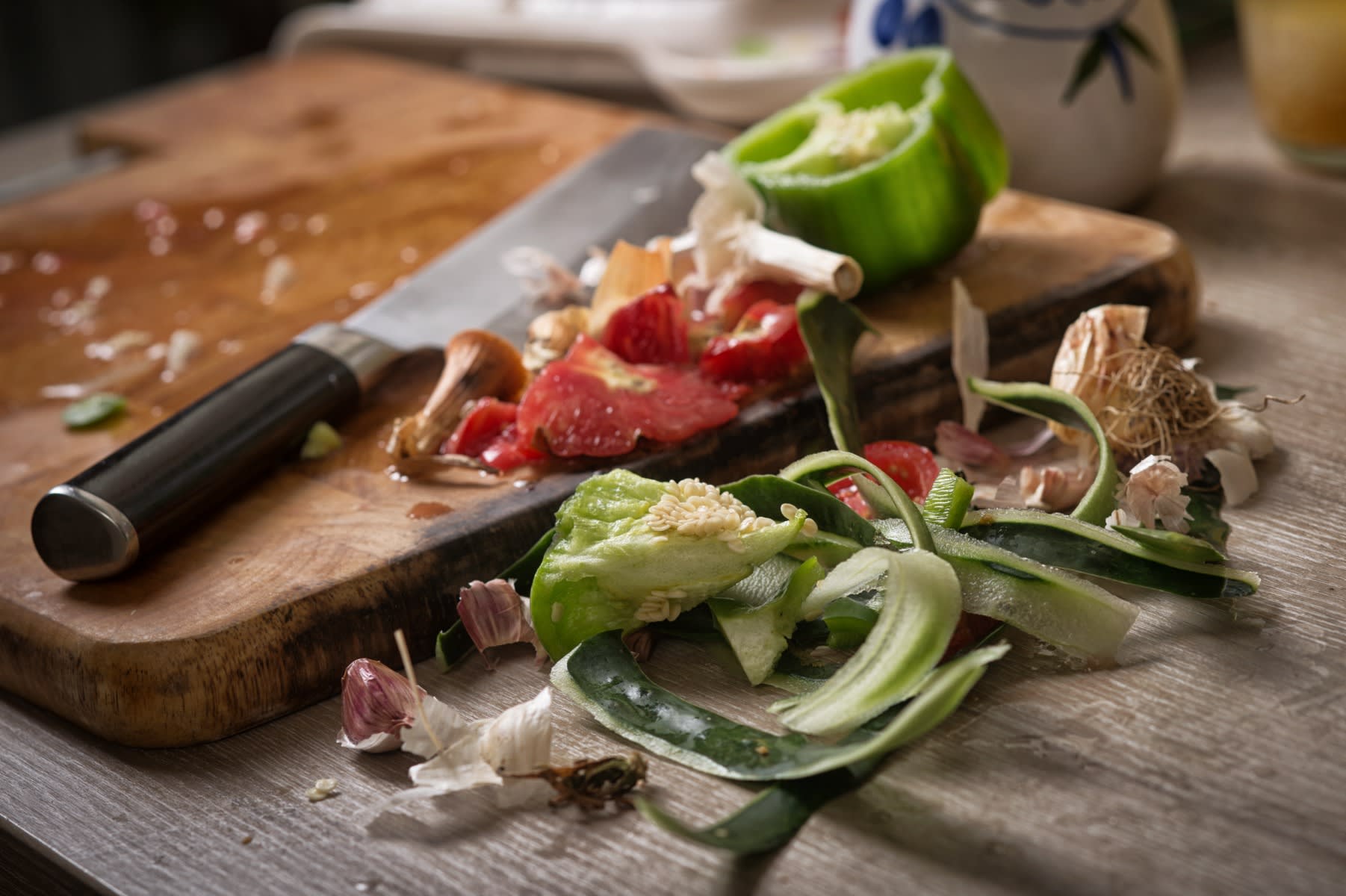 AdobeStock image of kitchen scraps and a knife on a cutting board