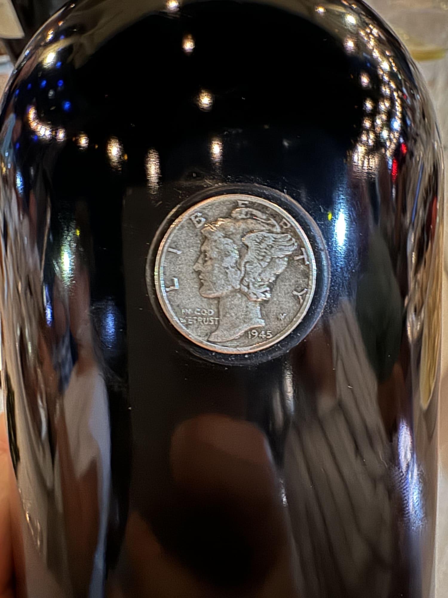 ...with an actual 1945 dime embedded in the bottle lol