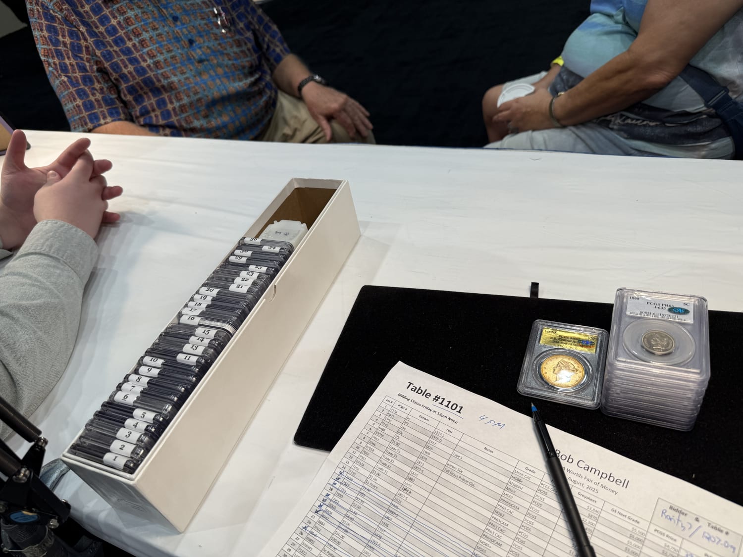 Filling out bids at Bob’s dealer auction