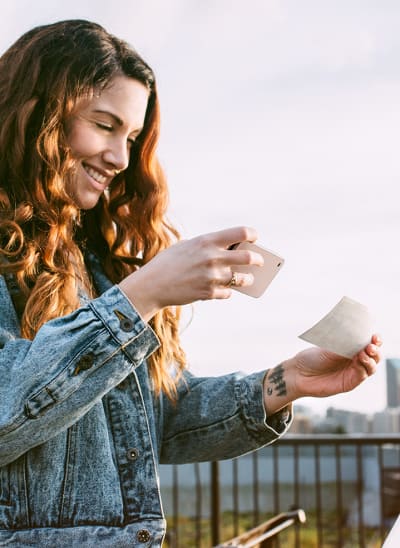 Woman using phone to complete a mobile banking transaction.