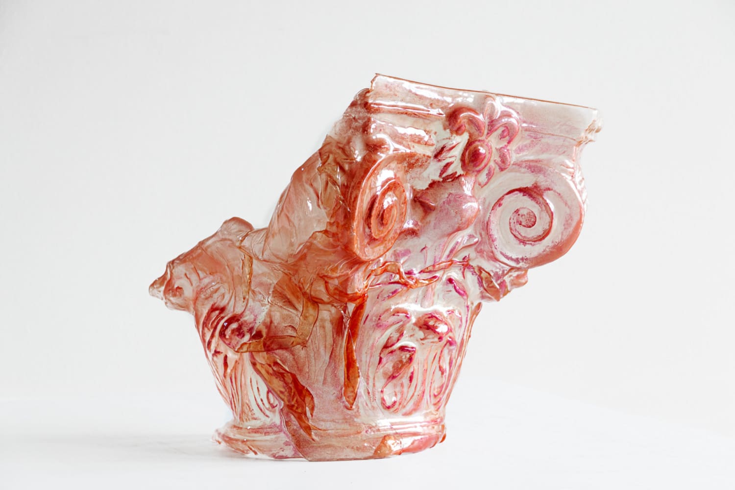 The image depicts a sculpture of a partially melted down translucent column chapitel. 