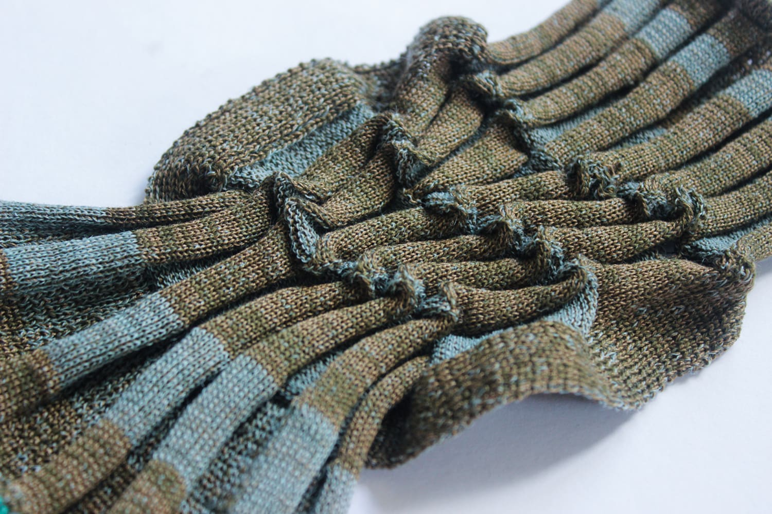 Deadstock cotton and wool swatch with twisting detail, colour varying from plaiting. Blue/khaki tones