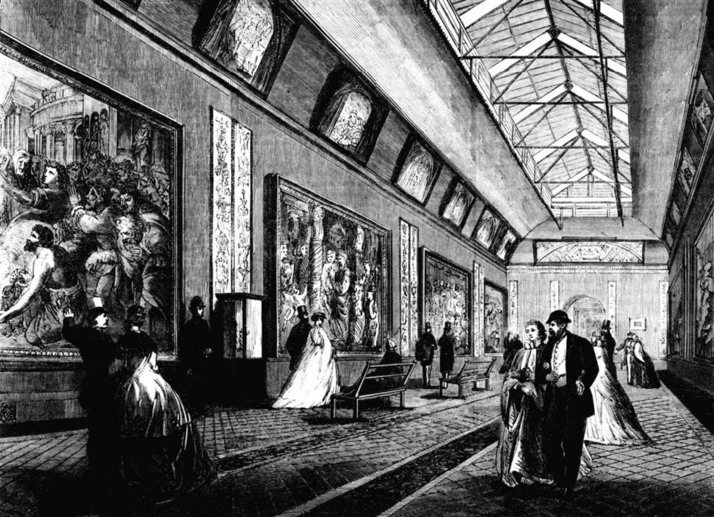 Engraving of the Raphael Gallery at the South Kensington Museum in 1865, with visitors walking and looking at the pictures.