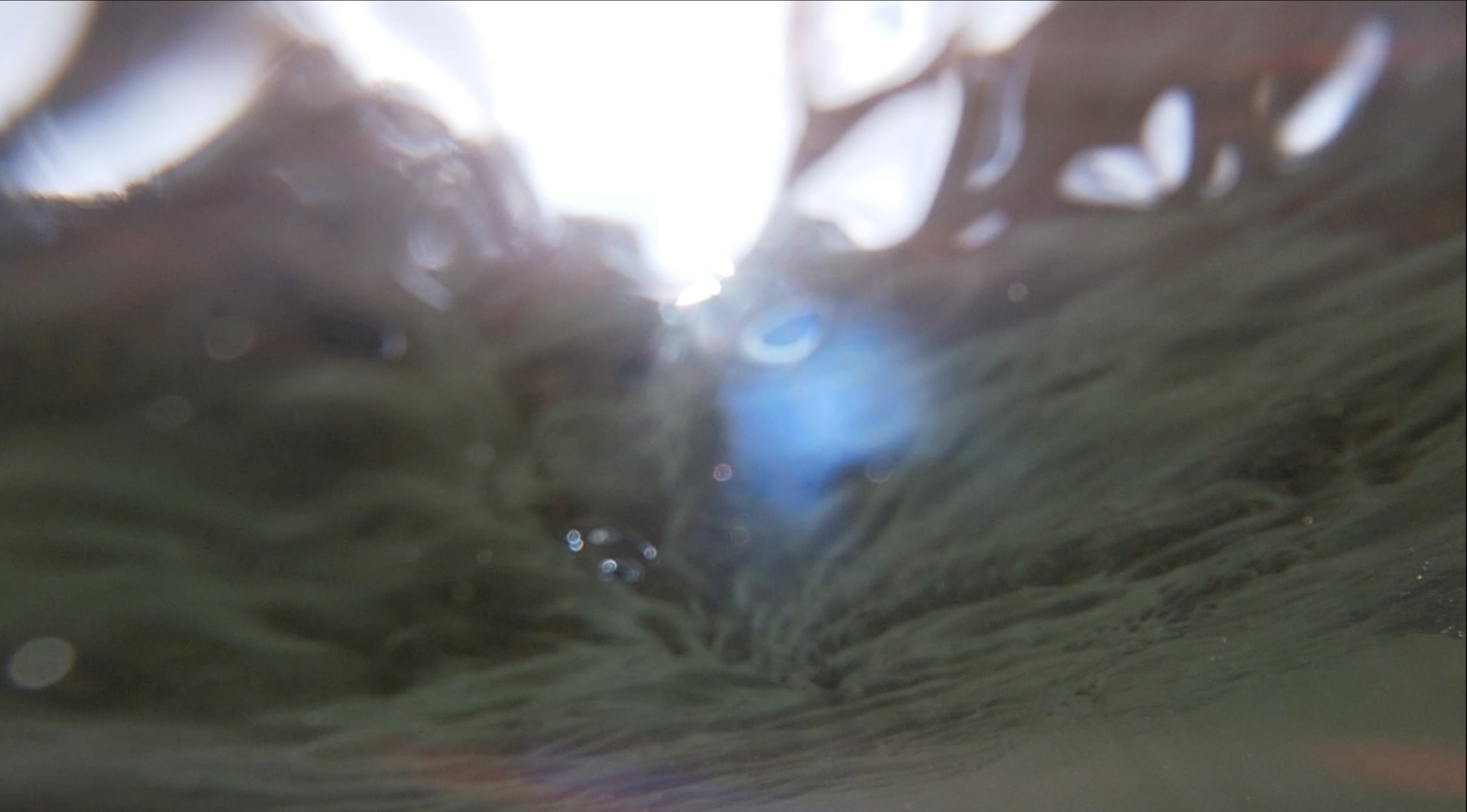 a blurry green and white image from underwater 