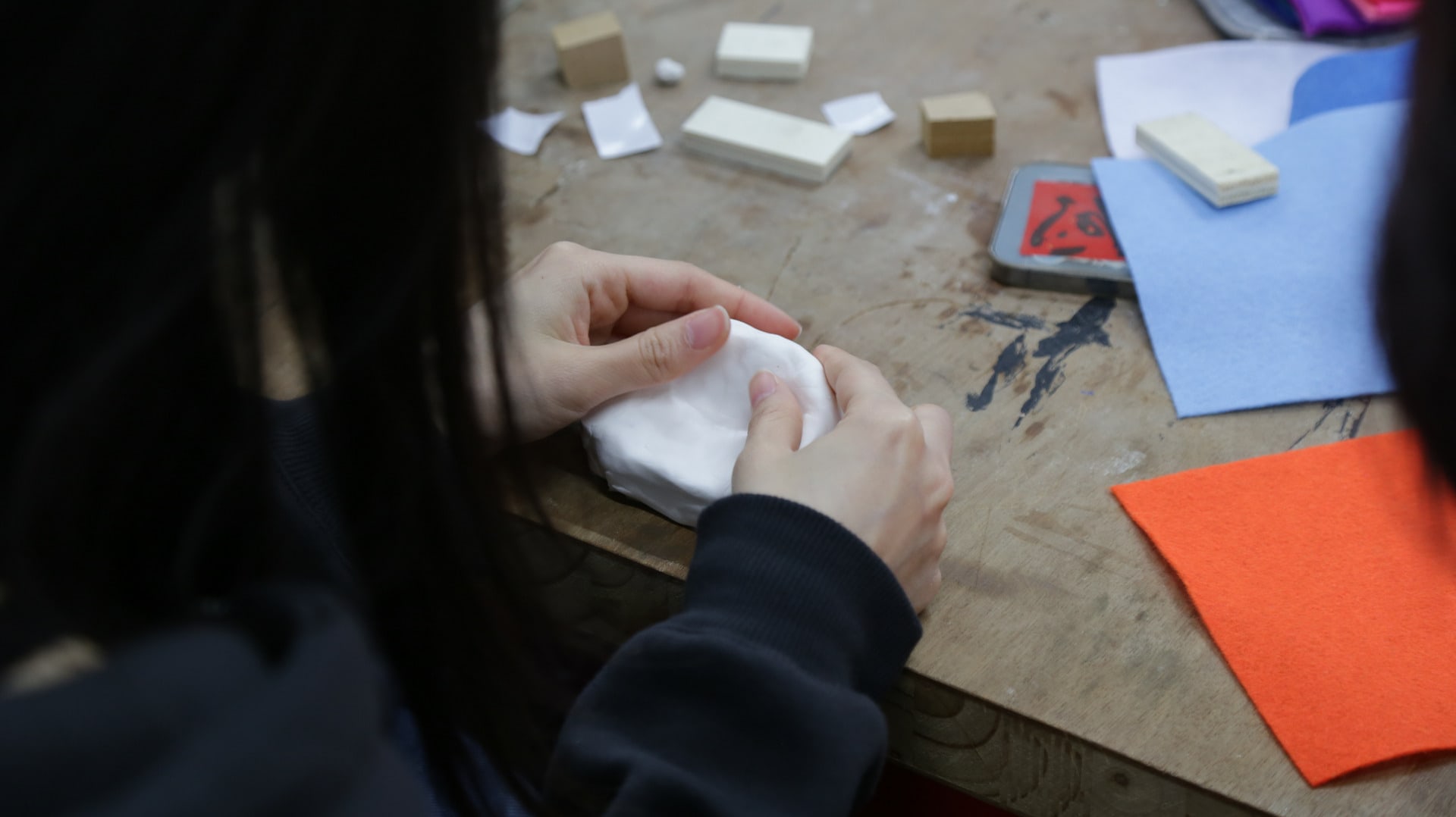 Image of someone's hands moulding clay