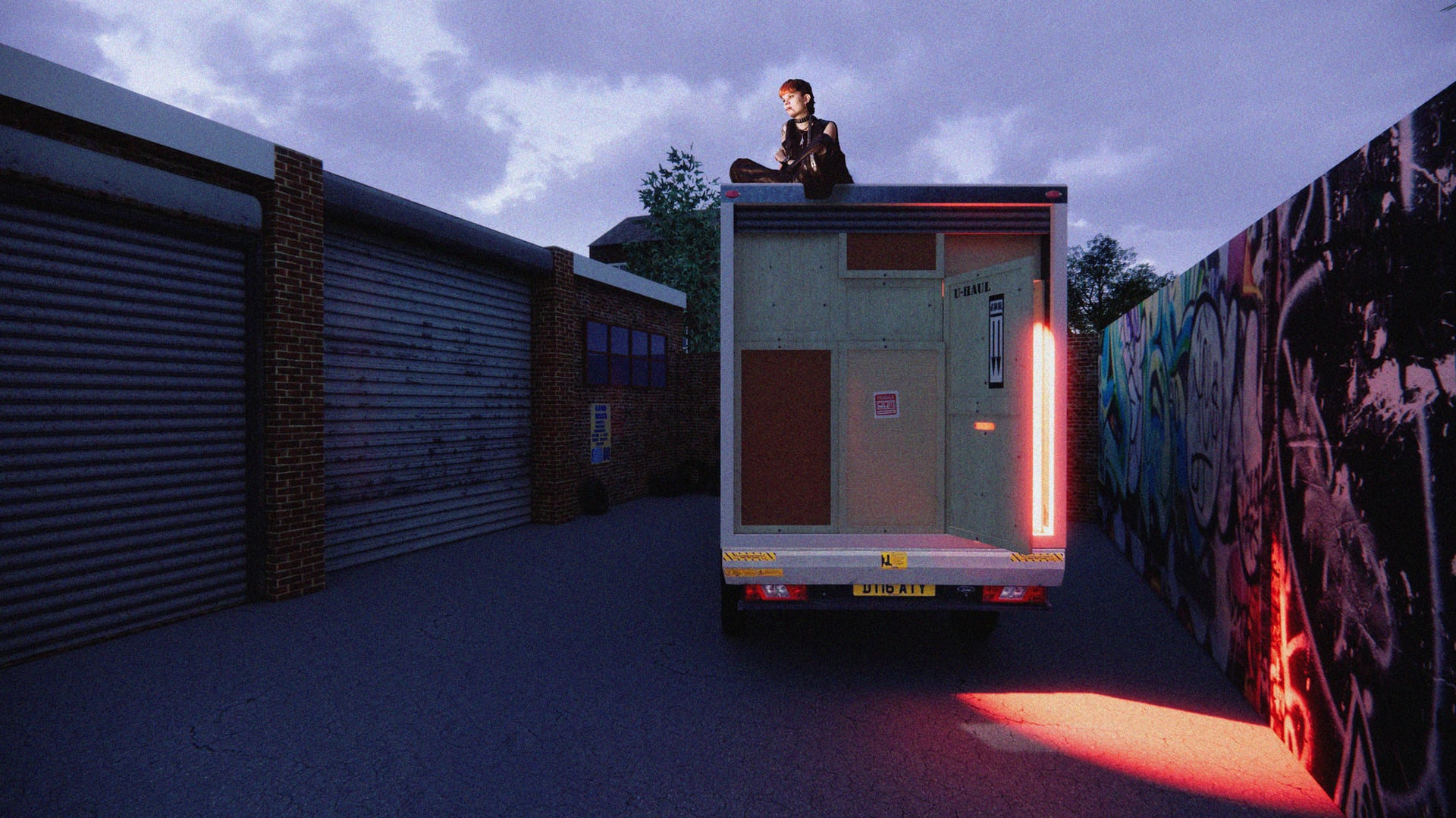 Digital render of the back of a Luton van, filled with packing crates and a partially open door - revealing red light inside