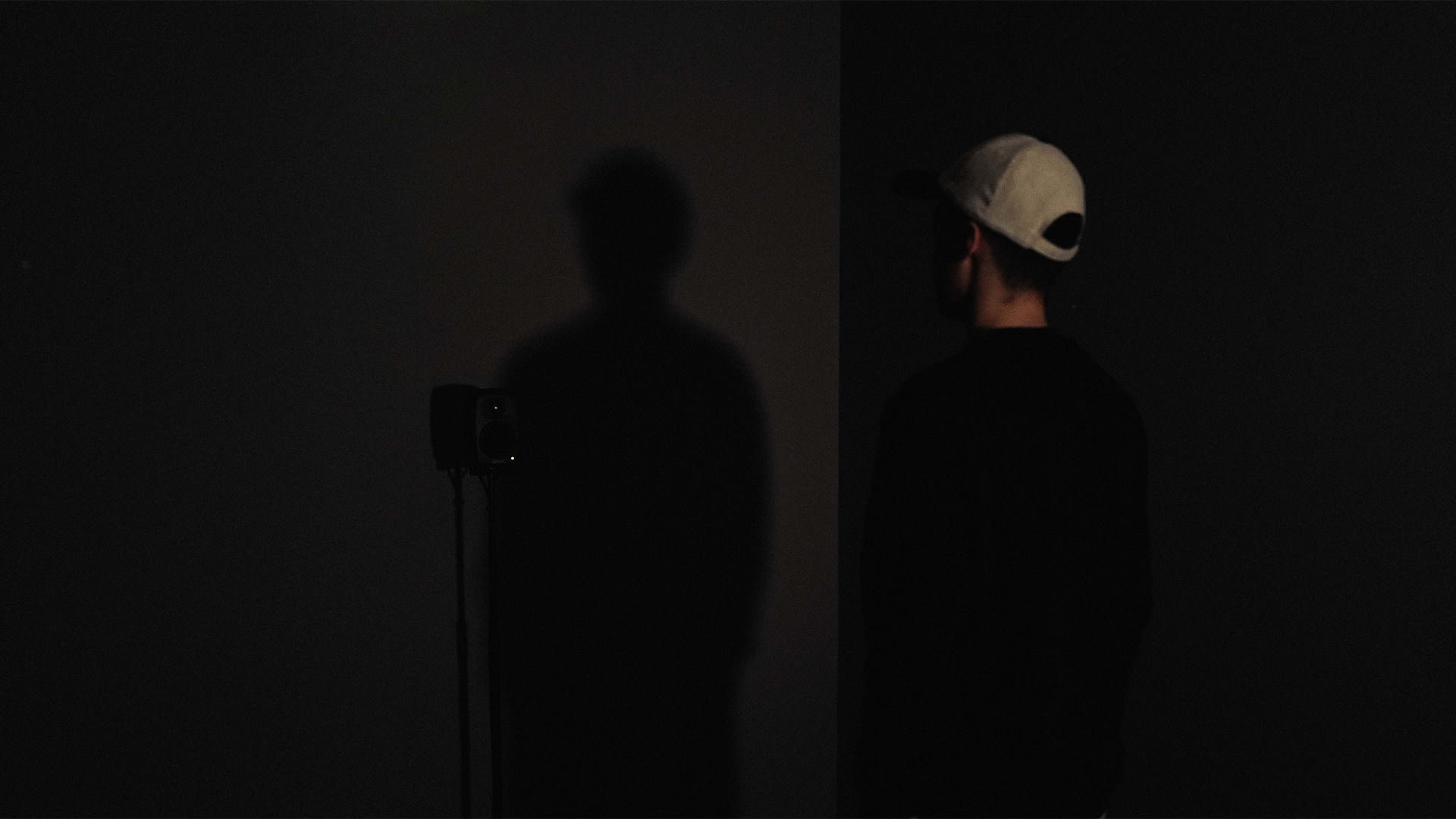 Bryan, his shadow and a mono speaker in the installation