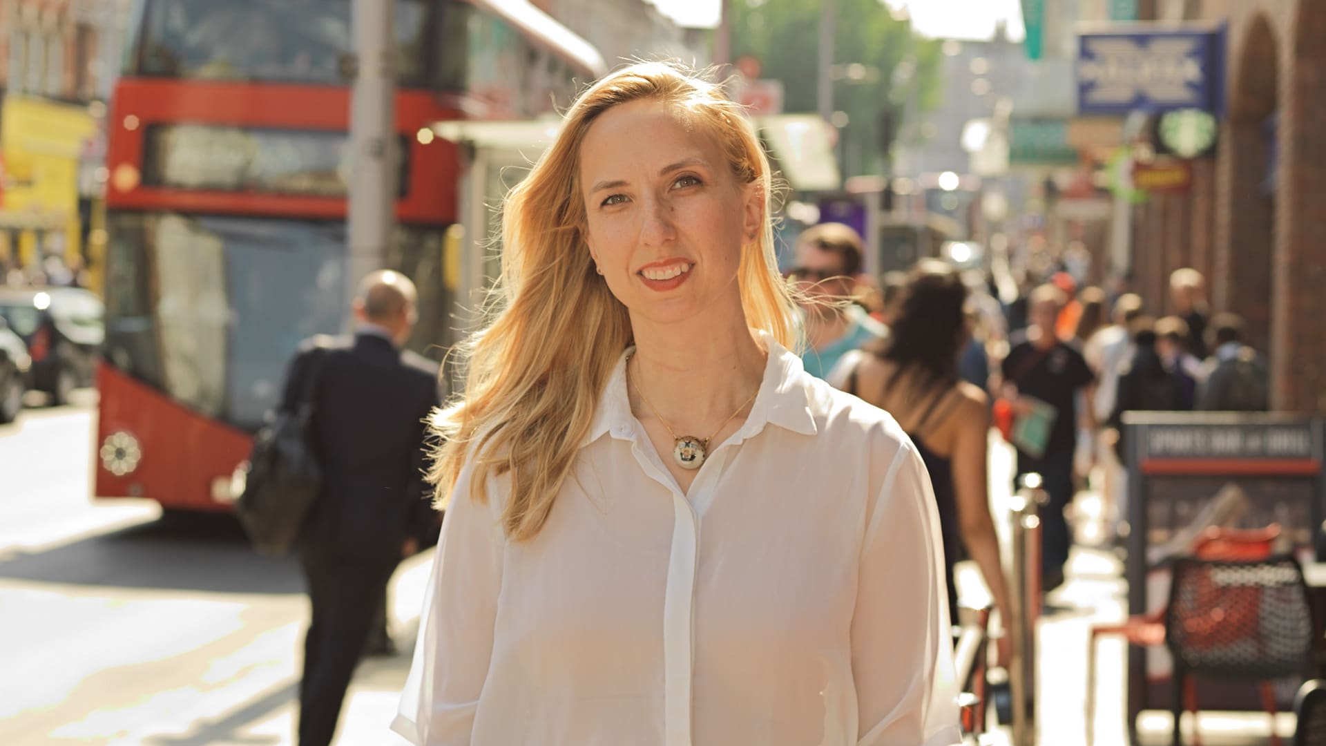 Ivana stands in the middle of a busy London city street