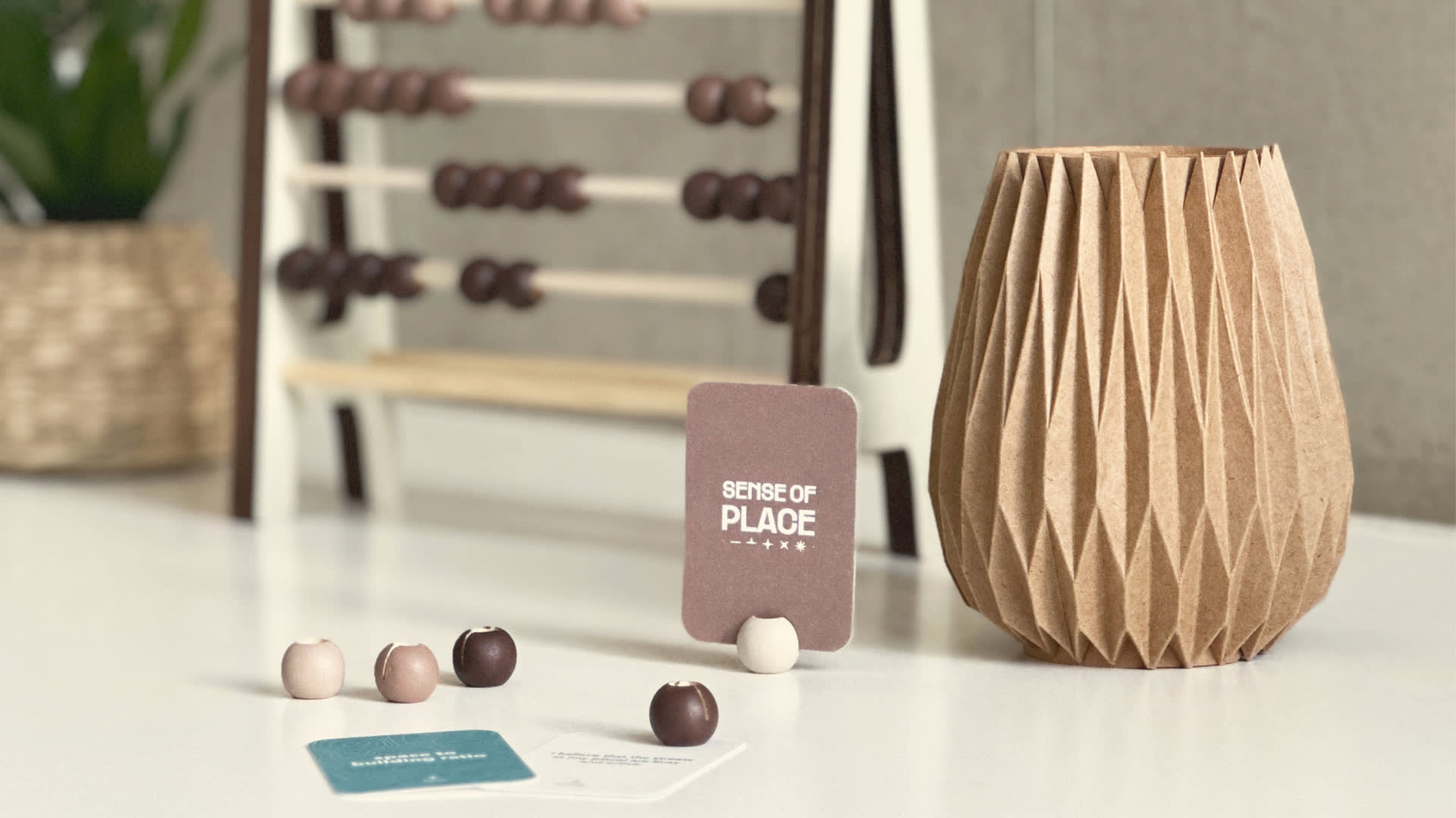 The Sense of Place Toolkit, featuring the companion and several beads and cards scattered in front of the slider.