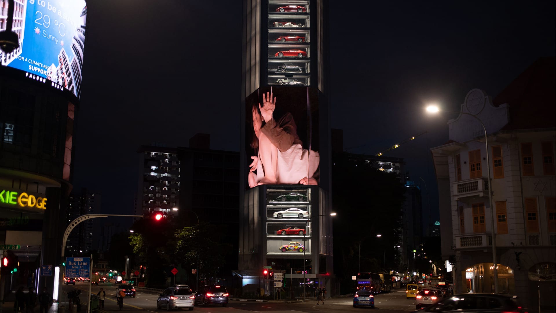 A giant human inside a box on a large LED screen on a tall building in Singapore, alternative viewing angle so it looks skewed