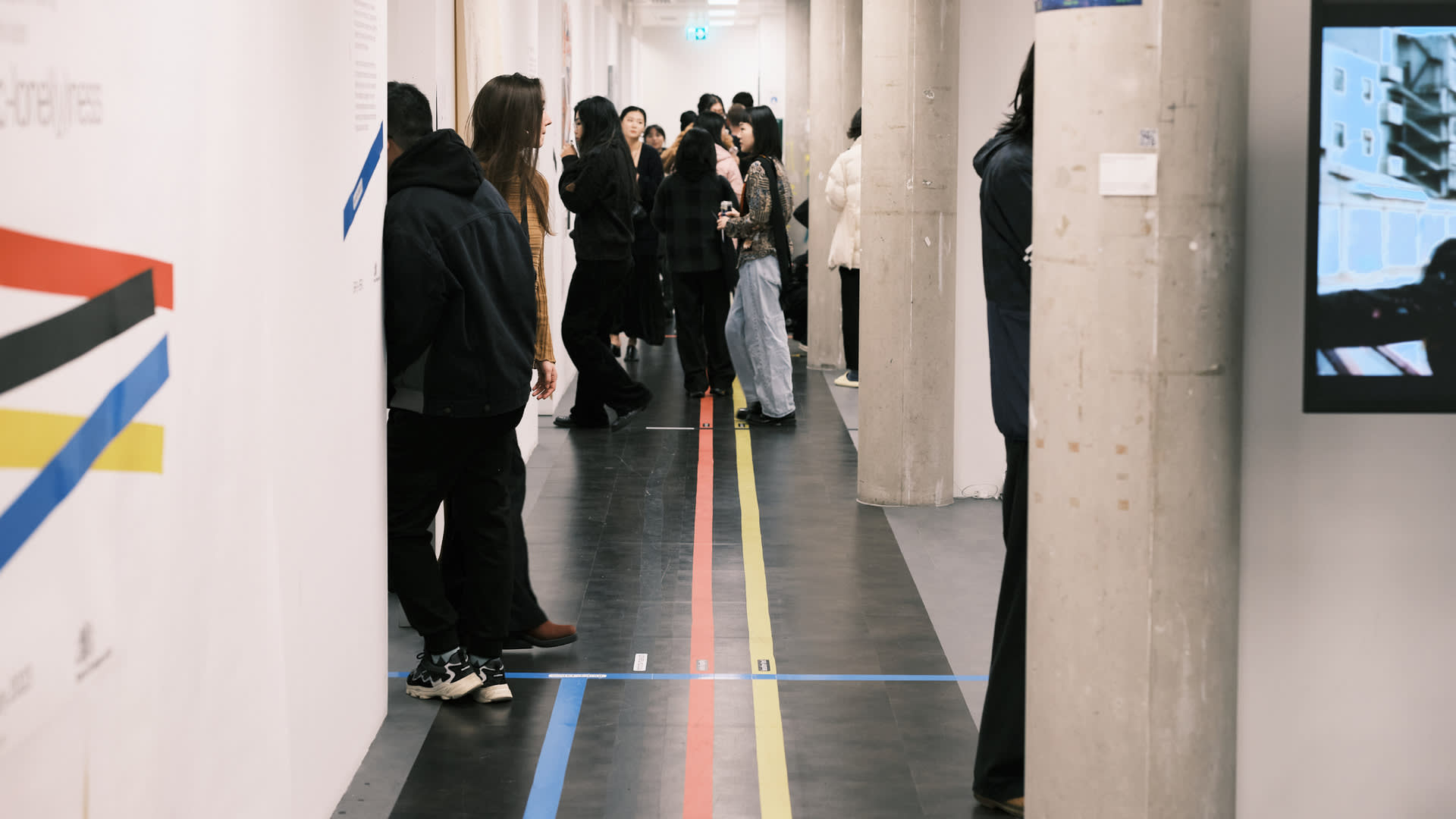 The exhibition space at White City campus with wayfinding across the ground. 