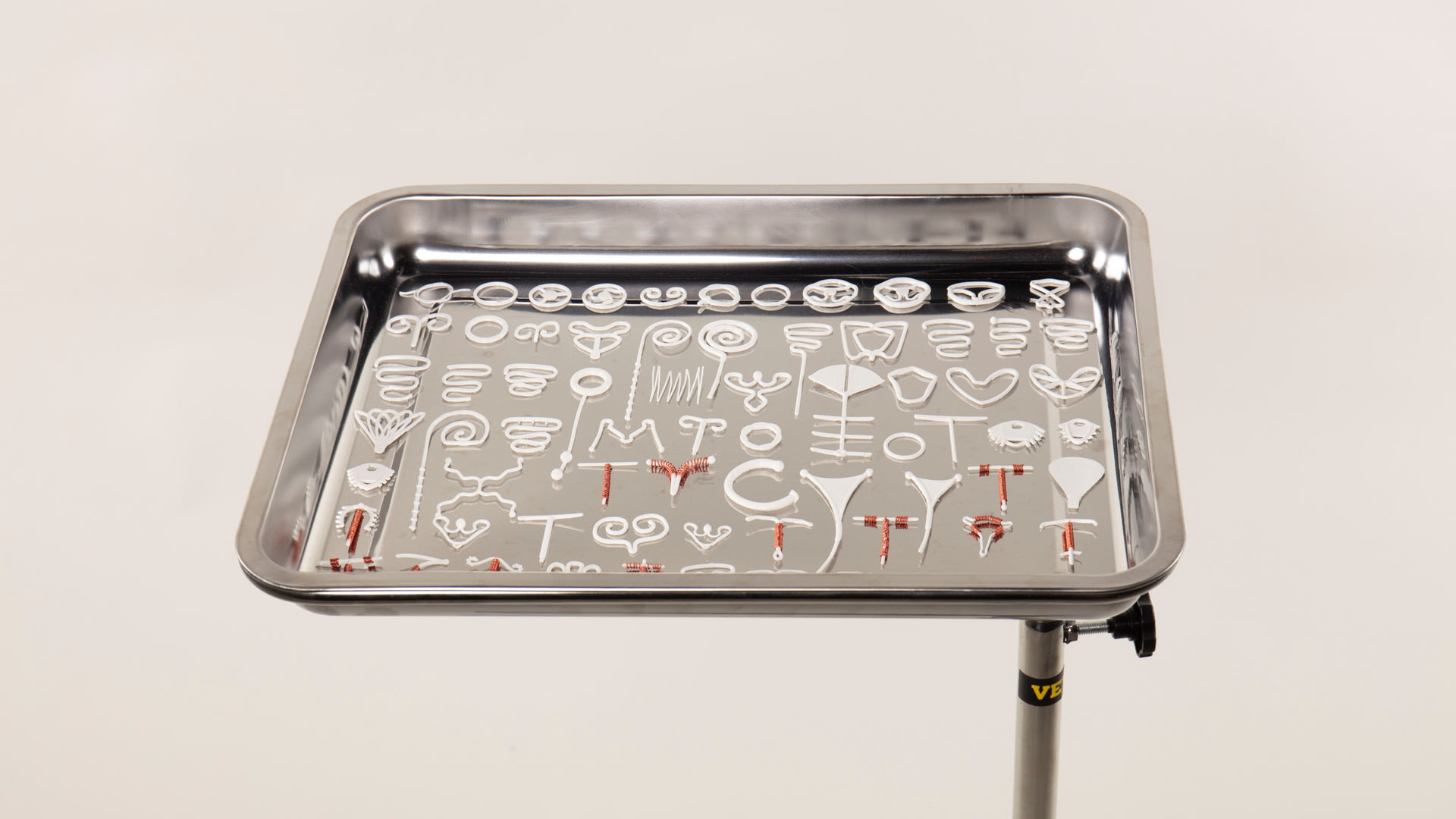 Photograph of 3d printed IUDs and IUS’ in their sequence of development starting with the ‘Richter Ring’.