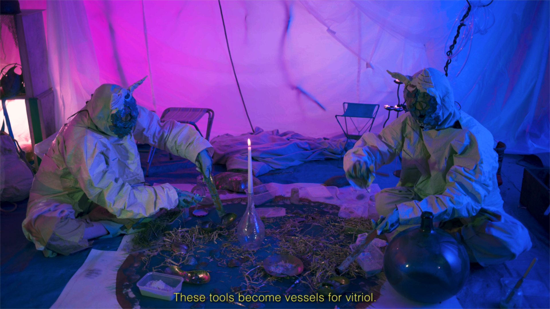 Still from Artist's film entitled True Medicine.  Two performers in dragon costumes perform a ritual.