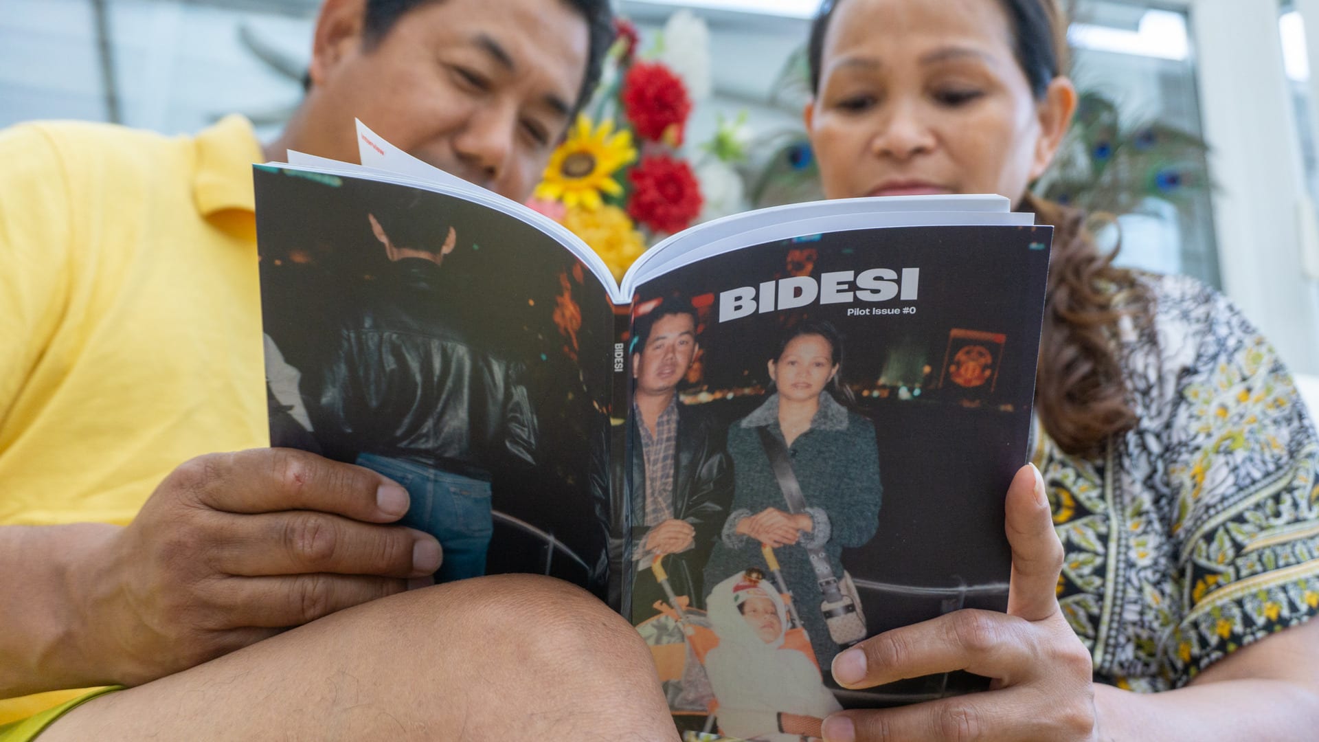 Ashmina's father and mother sat together, holding Bidesi Zine open and reading