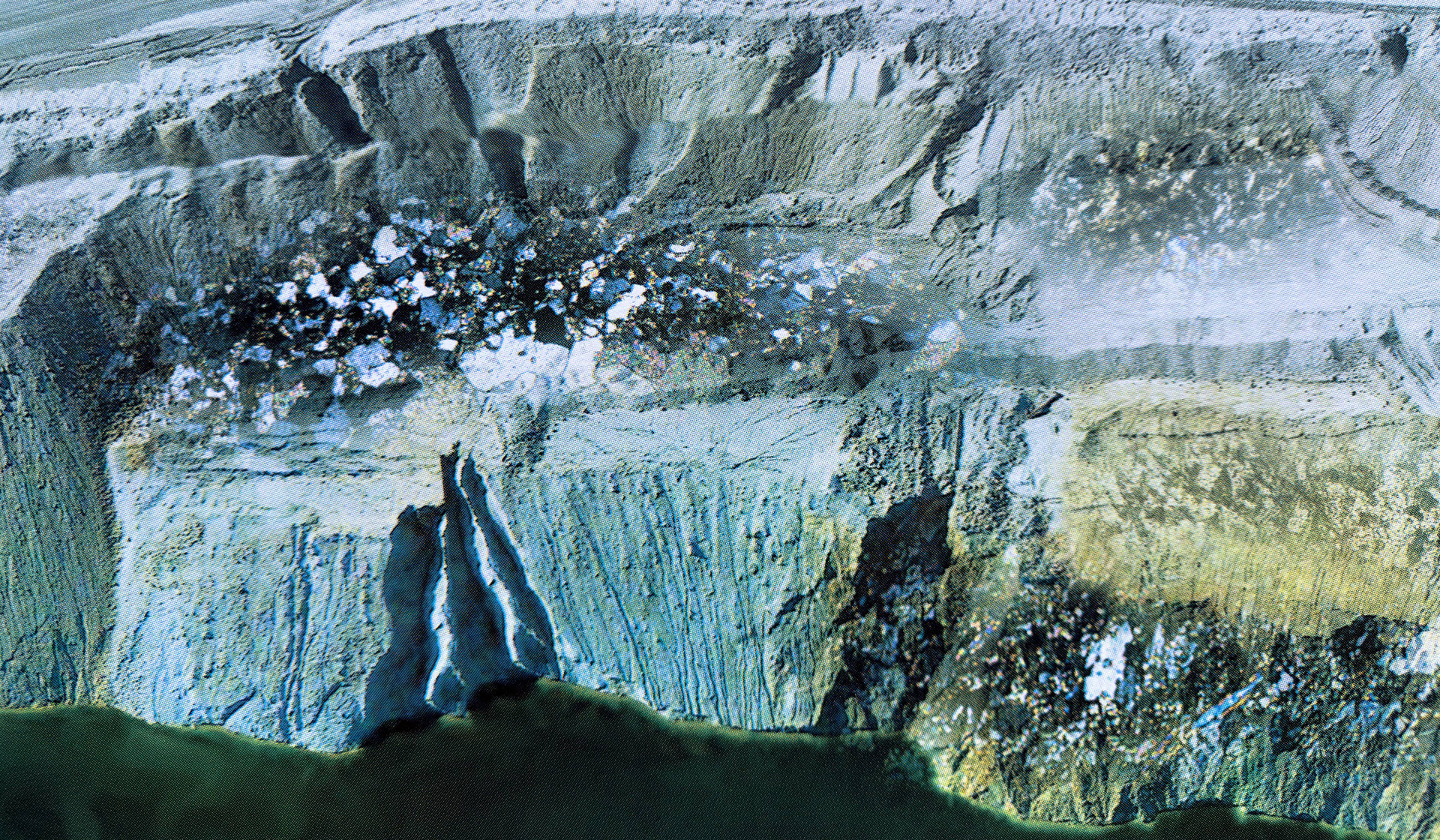 Screen print on paper depicting microscopic and satellite imagery of the landscape at an open pit mine.