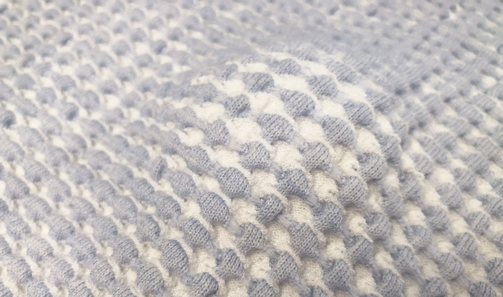 Blue and white warped knitted fabric