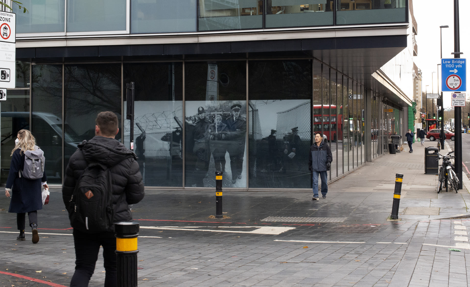 a busy pedestrian area with photographs of women protestors