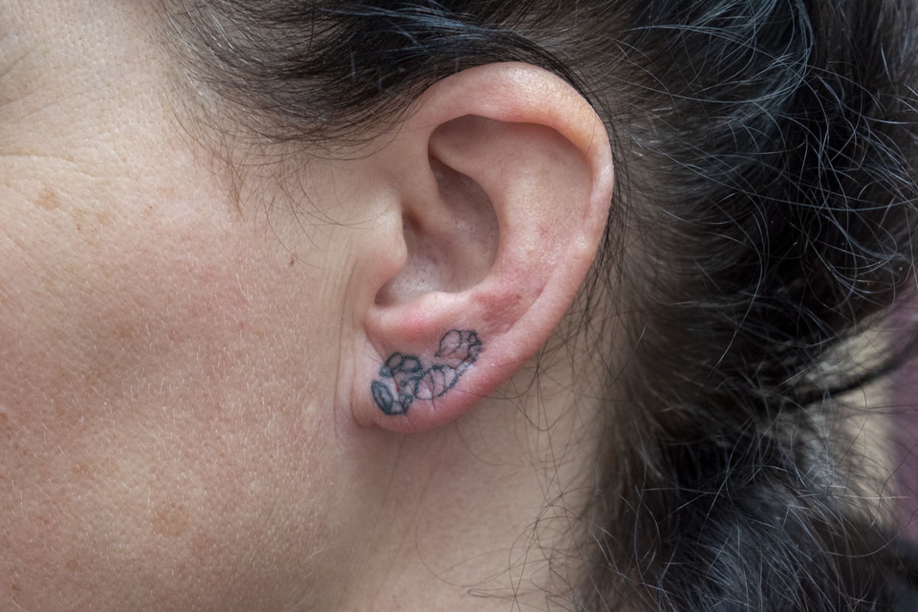 The artist's left ear, tattoed with the image of a scorpion, after the actress Eiko Matsuda. 