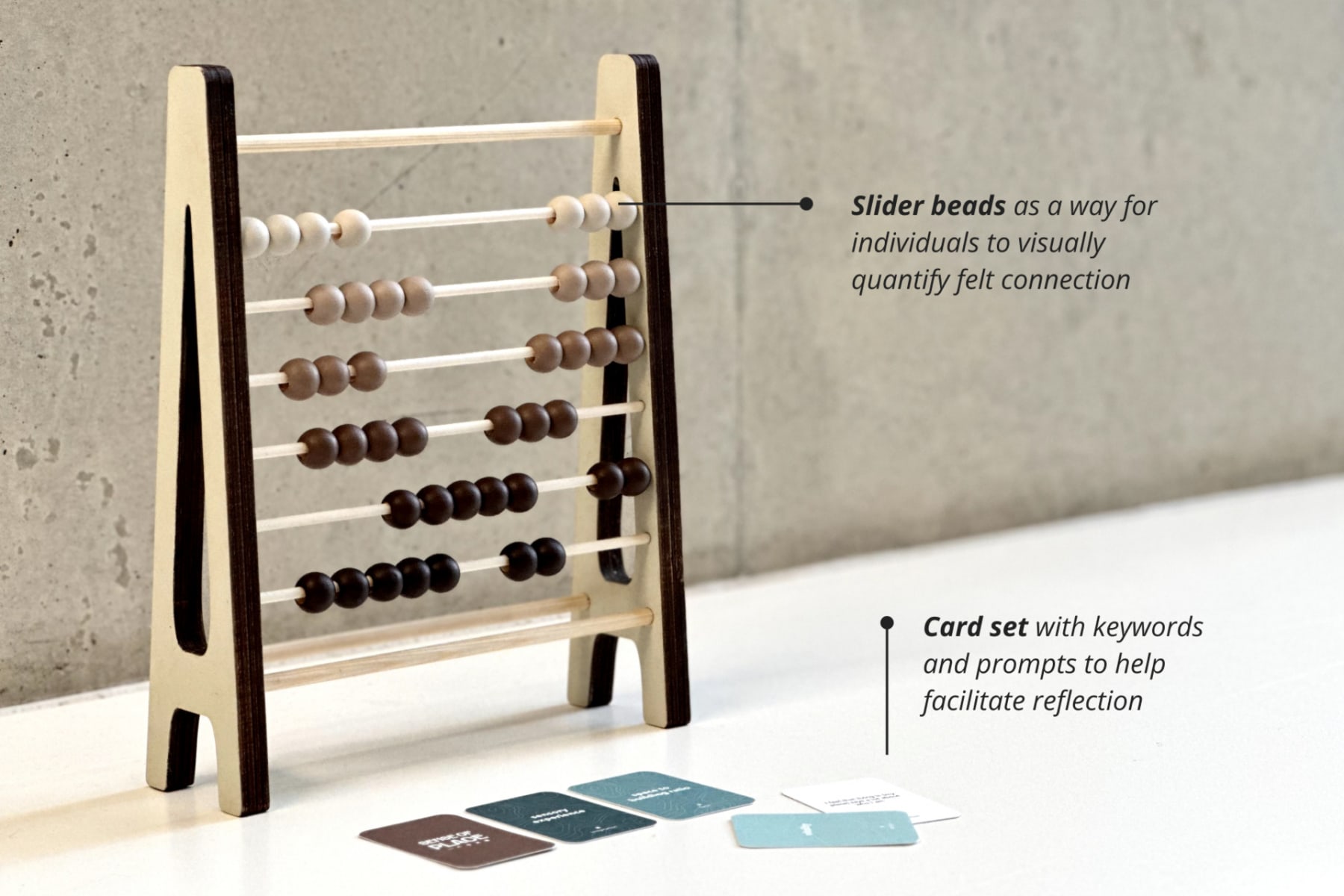 The Indoor Reflection Set, featuring an abacus style slider with beads in a gradient of colors; a deck of cards