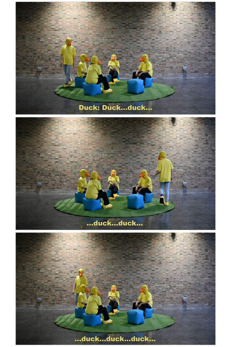Performance, 4 people dressed as ducks sat on beanbags.
