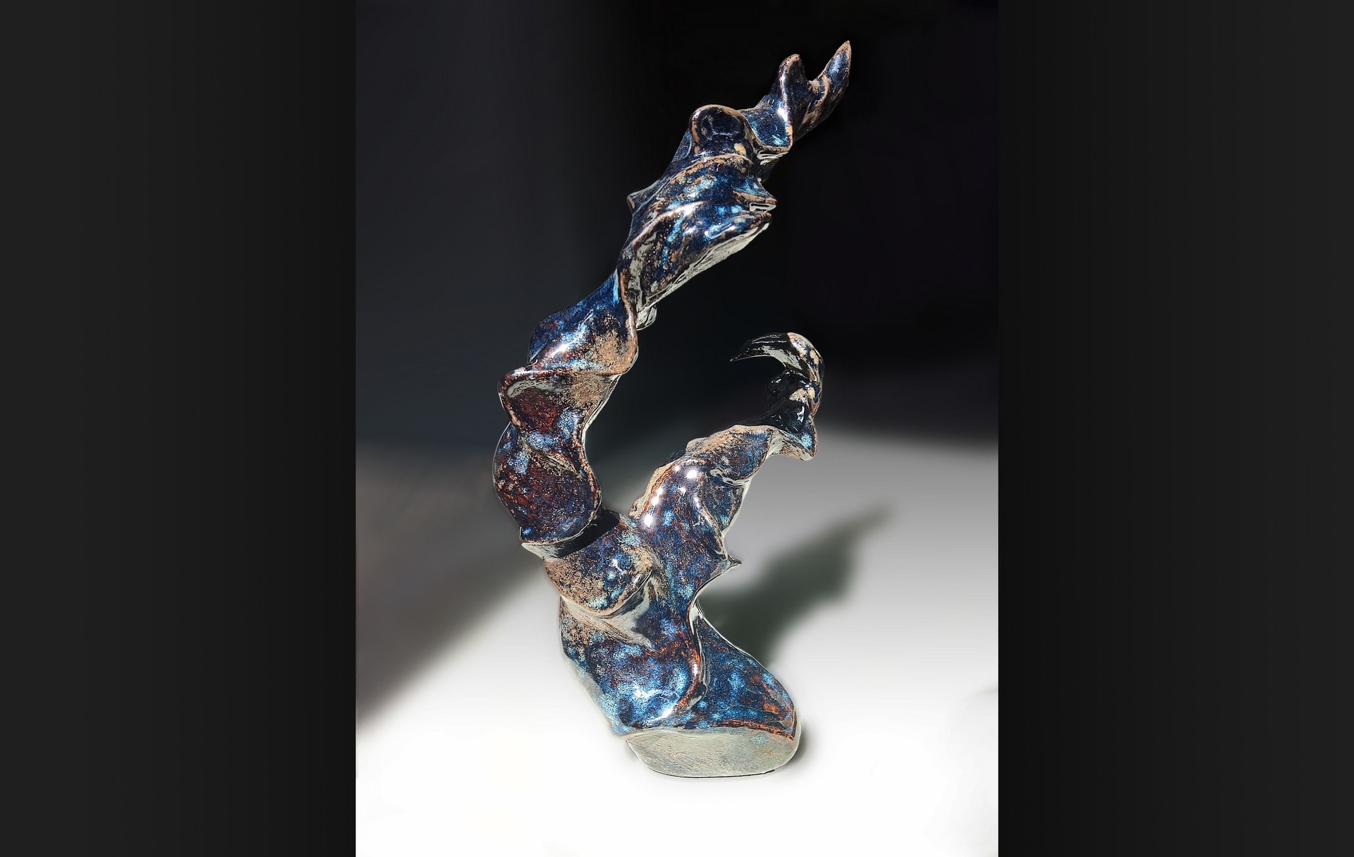 A sulpture's blue glaze shiny under sunshine