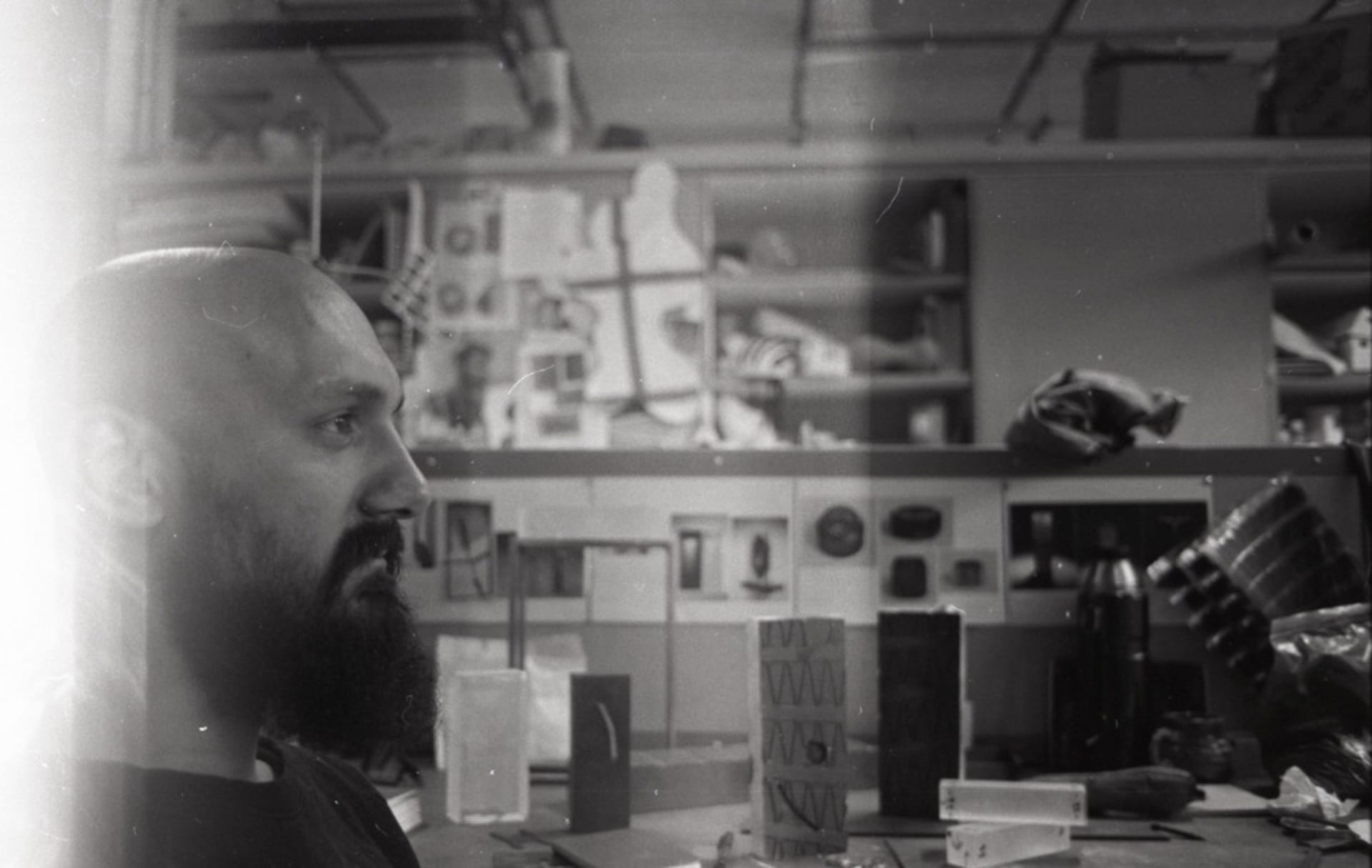 Scanned image of black and white negatives of work in progress shots, (silver ring making, metal working, pottery)