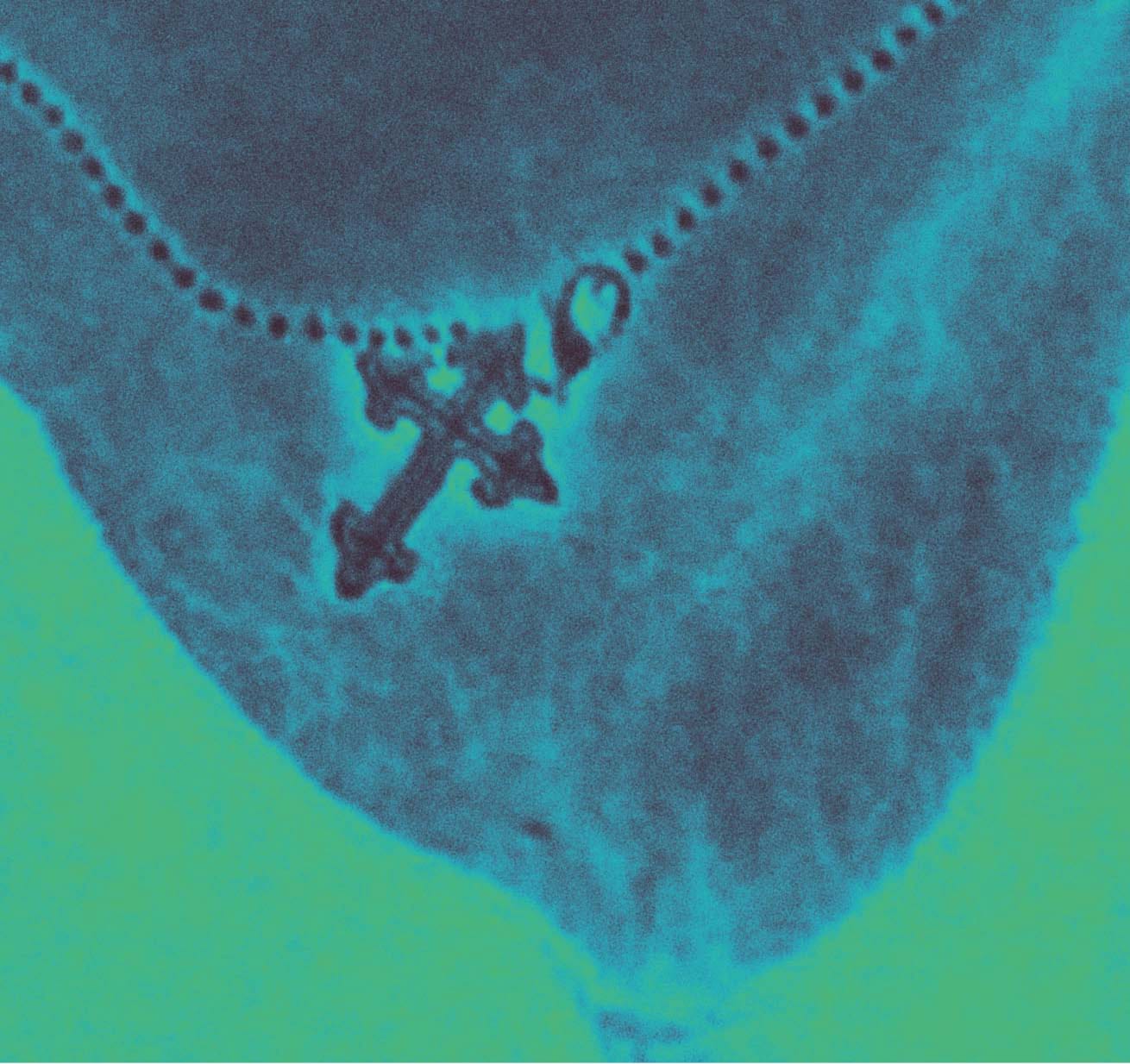 Picture of a necklace with a Christian cross pendant edited in a blue and green film