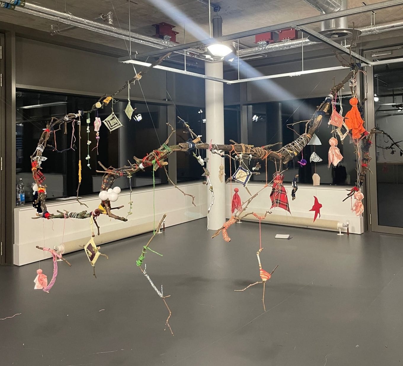 A large-scaled Installation that is structured like a wind chime, with small sculptures made out of found material suspended