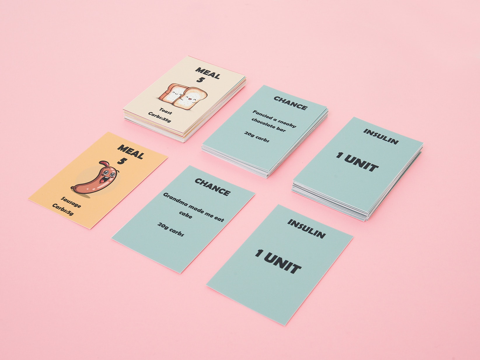 An image showing 5 different game cards: meal cards with points and images of food, chance cards, and insulin cards.
