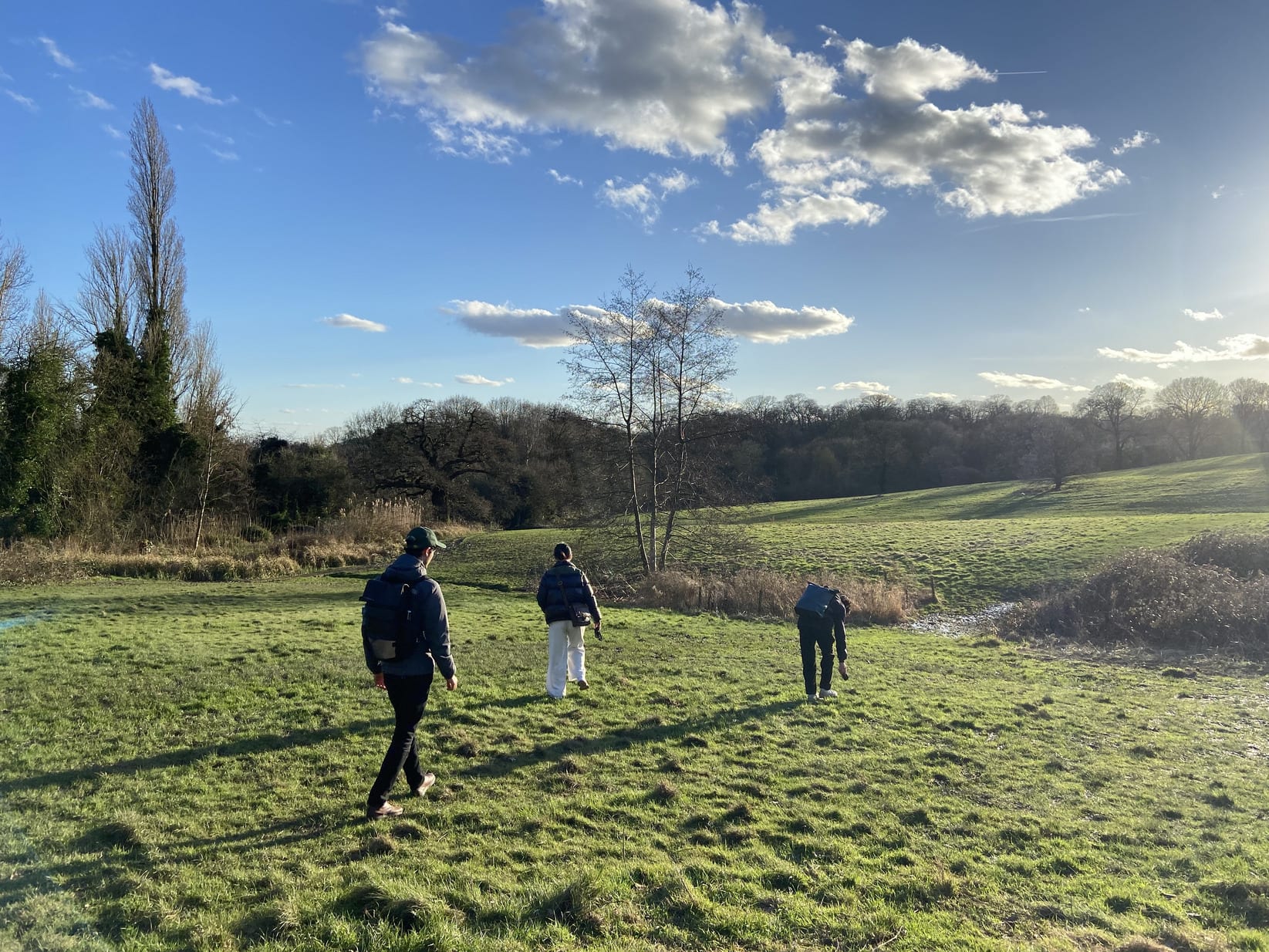 A photo of 3 group members walking in Hampstead Heath.