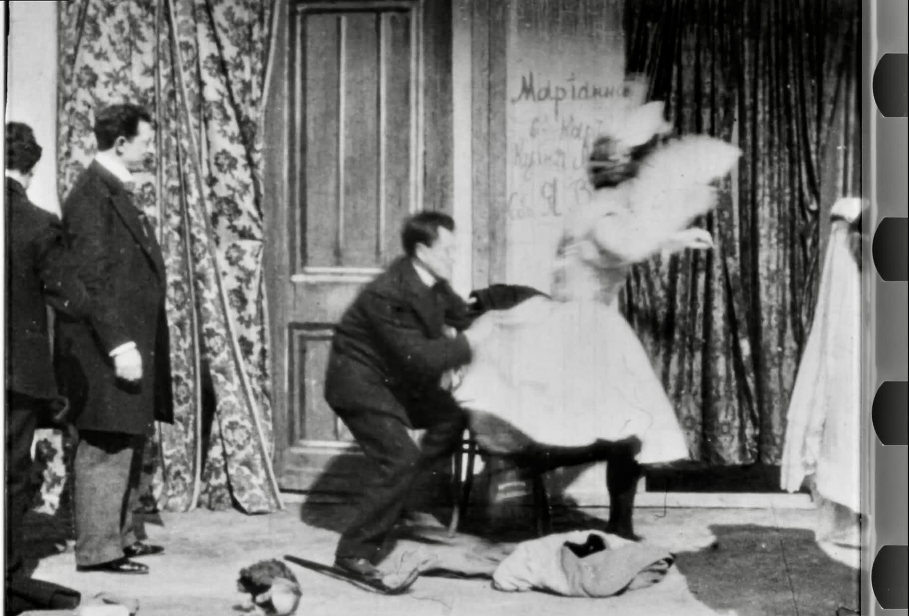 Quick-change artist Leopoldo Fregoli runs backstage mid-costume-change helped by costume technicians