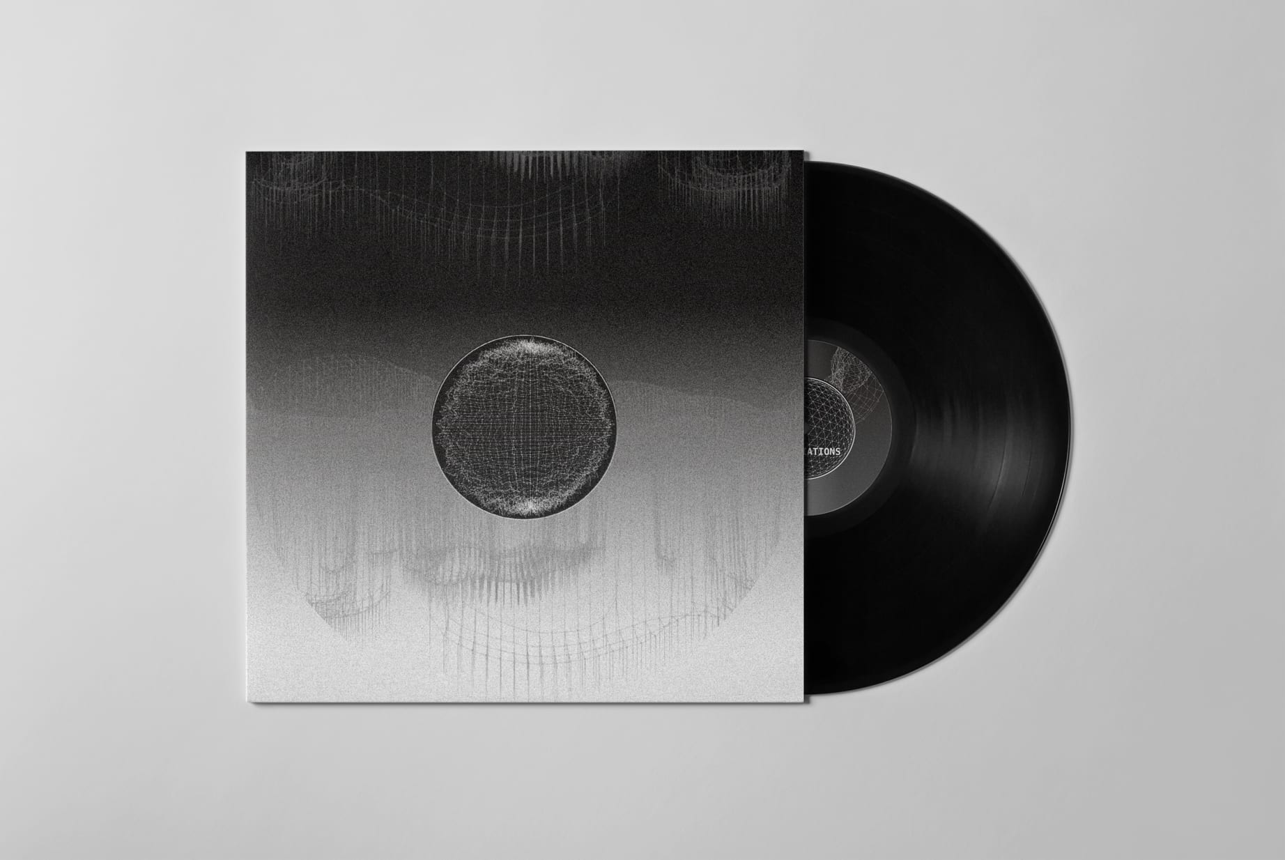 A vinyl record in gray packaging with an intricate pattern.