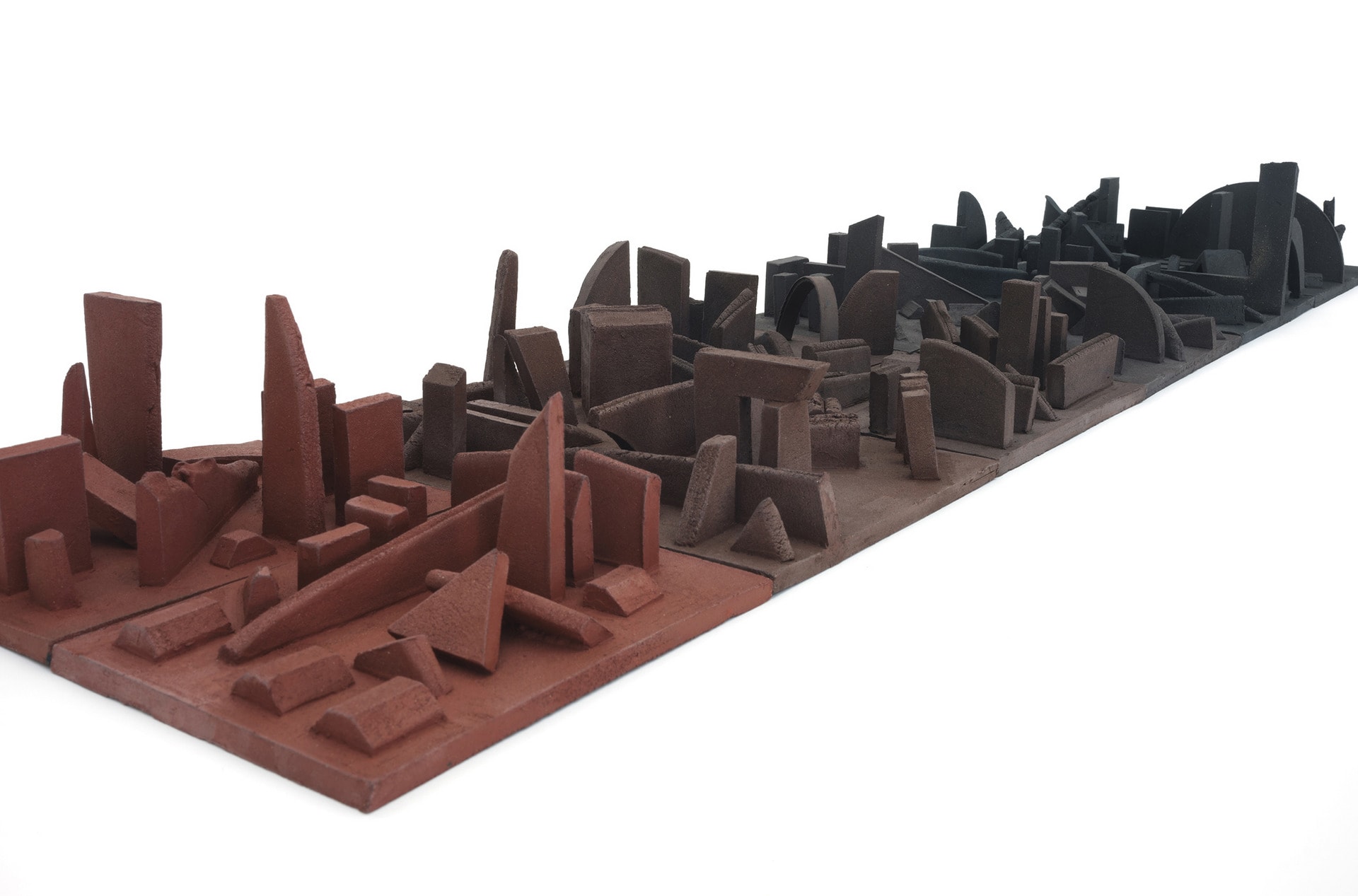 A set of clay tiles creating a frieze of a cityscape