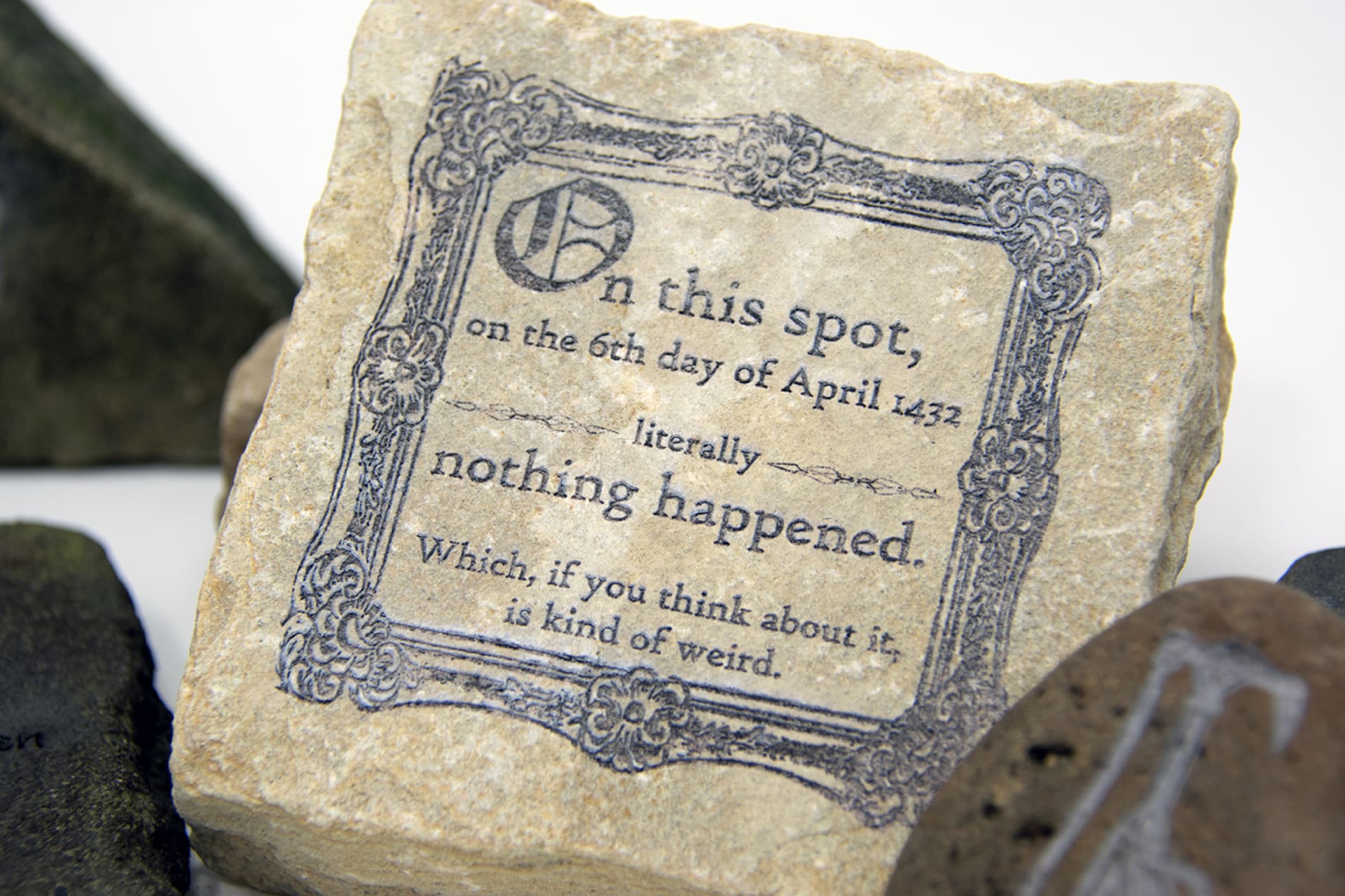 A square stone etched in Victorian decorations with a message saying letteraly nothing happened on this spot in April 6, 1432. 